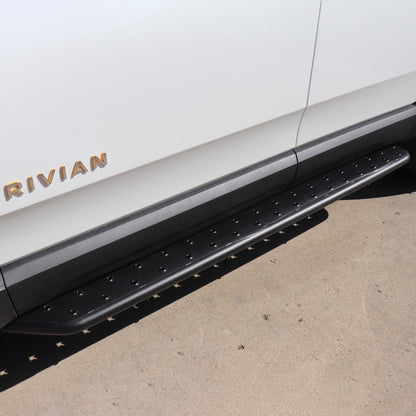Stainless Steel running boards installed on rivian glacier white R1S